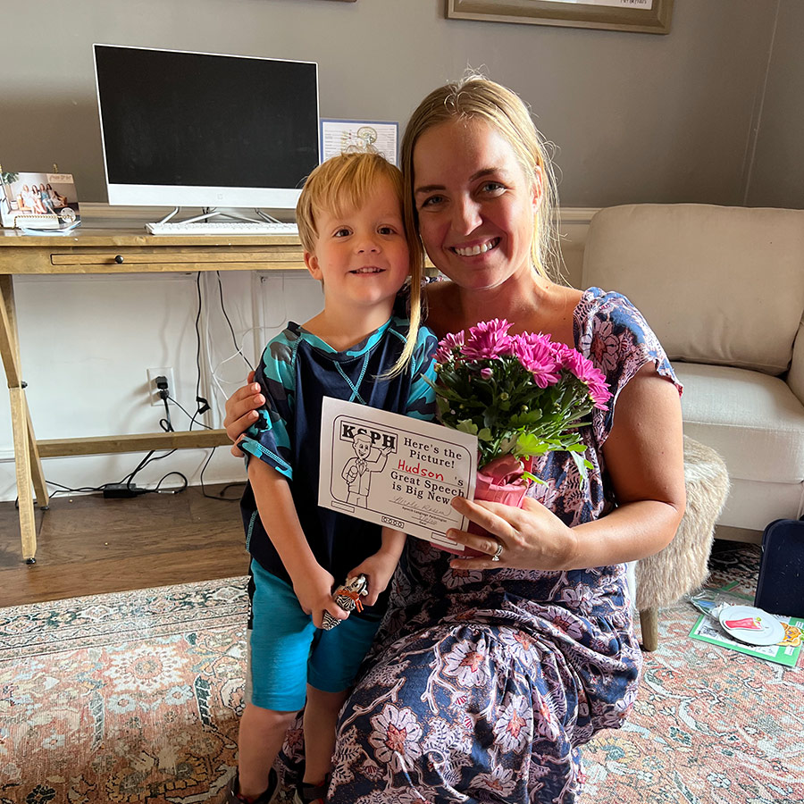 Nicole with a child celebrating speech progress